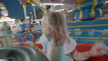 Delighted child in merry-go-round at night