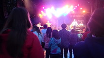 youth dancing to music at a concert 