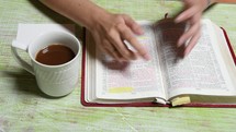 reading a Bible and a  coffee mug 