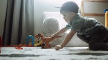 a toddler playing with dinosaurs 