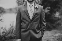 A groom poses for a photo