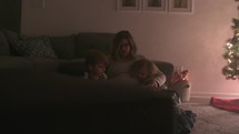 mother reading to her children at Christmas 