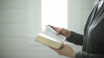 a woman reading from a Bible 