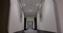 Timelapse of moving forward in empty light hotel corridor