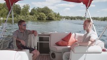 two men having a conversation on a boat 