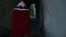 Santa Claus rushing down the streets of a village