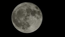 Full moon rising seen with an astronomical telescope