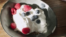 Healthy breakfast with granola, yoghurt and fresh berries