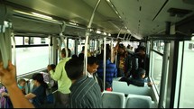 commuters in India riding on a bus 