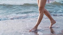Legs Of A Young Slender Ballet Dancer Girl Standing On Sandy Sea Shore.
