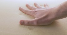 Hand pressing a memory foam bed