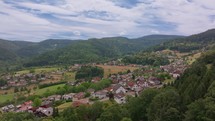 Aerial view of a small German village bordering a dense forest