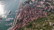 Kotor Montenegro: Coastal aerial tilt-up reveal showcasing old town and mountains
