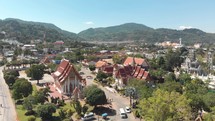 Wide Panoramic of Wat Chalong temple grounds on a hot sunny day in Phuket, Thailand - Aerial low angle wide Panoramic shot