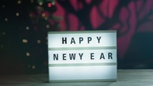 Happy new Year signboard under Christmas tree 