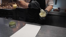 Chef Is preparing a white cream mayonnaise base for fish