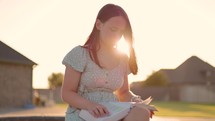 Girl Reading Bible Outside at Sunset