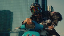 Man Wearing A Full Face Helmet Sits On A Motorbike
