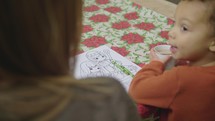child coloring a Christmas coloring page 