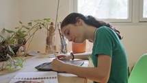 Teenage girl drawing using a tablet computer and an electronic pen