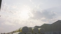 Large stacks of cotton bales at a cotton gin after harvest