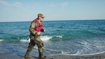 Miltary marine american man training run in the shore during winter