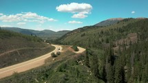 Aerial drone flying over a highway in the Colorado Rocky Mountains. 