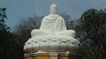 Panorama of a large Buddha statue meditating in the middle of the jungle. Static shot