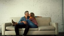 a couple kissing on the couch 