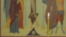 Crucifixion of Christ icon with candle.
