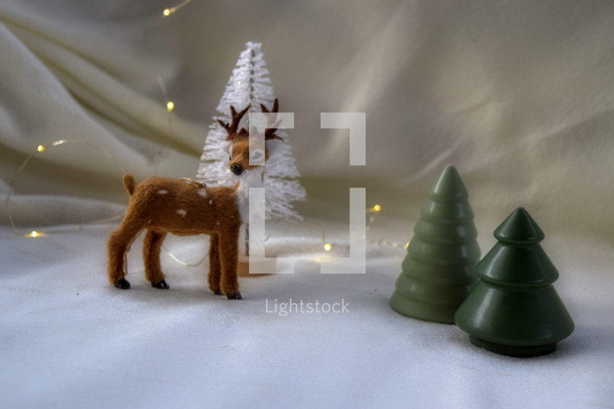 deer figurine and Christmas trees 
