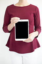 a woman holding a tablet 