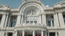 People walking Outside of Bellas Artes Museum in Mexico City - Tilt up shot	