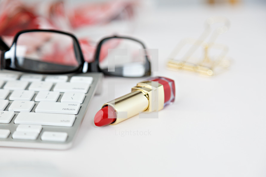 reading glasses, computer keyboard, red lipstick, floral scarf 