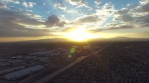 aerial view over a city and suburbs at sunset 