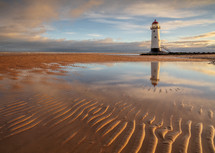 lighthouse and ripples in sand 