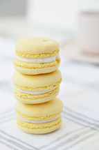 macaroons stacked on a plaid tablecloth 