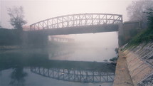 Bridge on river at dawn.
