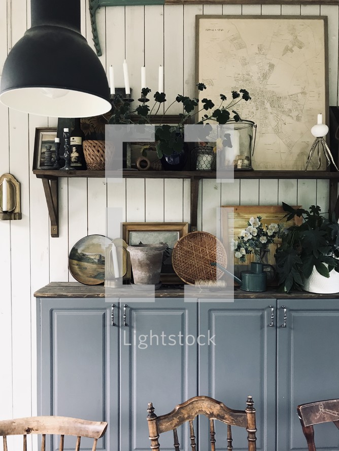 items on a cabinet behind a dining room table 