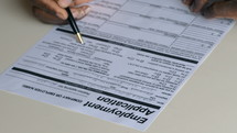 a man filling out an employment application 