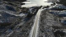Drone footage of a road leading to a frozen loch in Scotland.