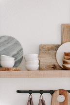 marble cutting board and bowl on a wood shelf 
