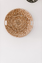 straw baskets hanging on a wall 