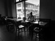 man sitting alone in a coffee shop 
