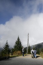 Man looking at phone in beautiful mountain scenery