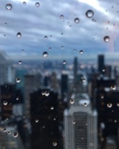 water droplets on a window and view of a city 