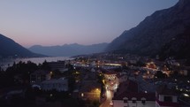 Montenegro Kotor, evening cityscape, bay and mountain backdrop. Aerial