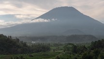 The Mighty Mount Agung of Bali Indonesia and Lush Green Rice Field - Beautiful Volcano Landscape Nature Time Lapse