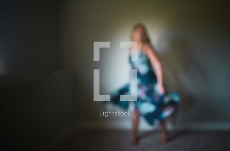 out of focus image of a woman in a floral dress 