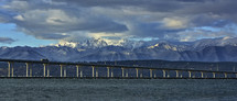 The Hood Canal bridge with the snowy Olympic mountain range in the background.